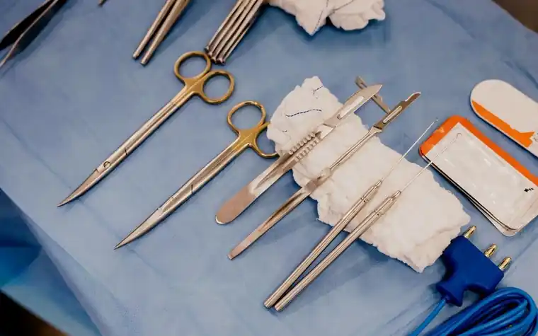 Surgical instruments laid out on a sterile blue drape